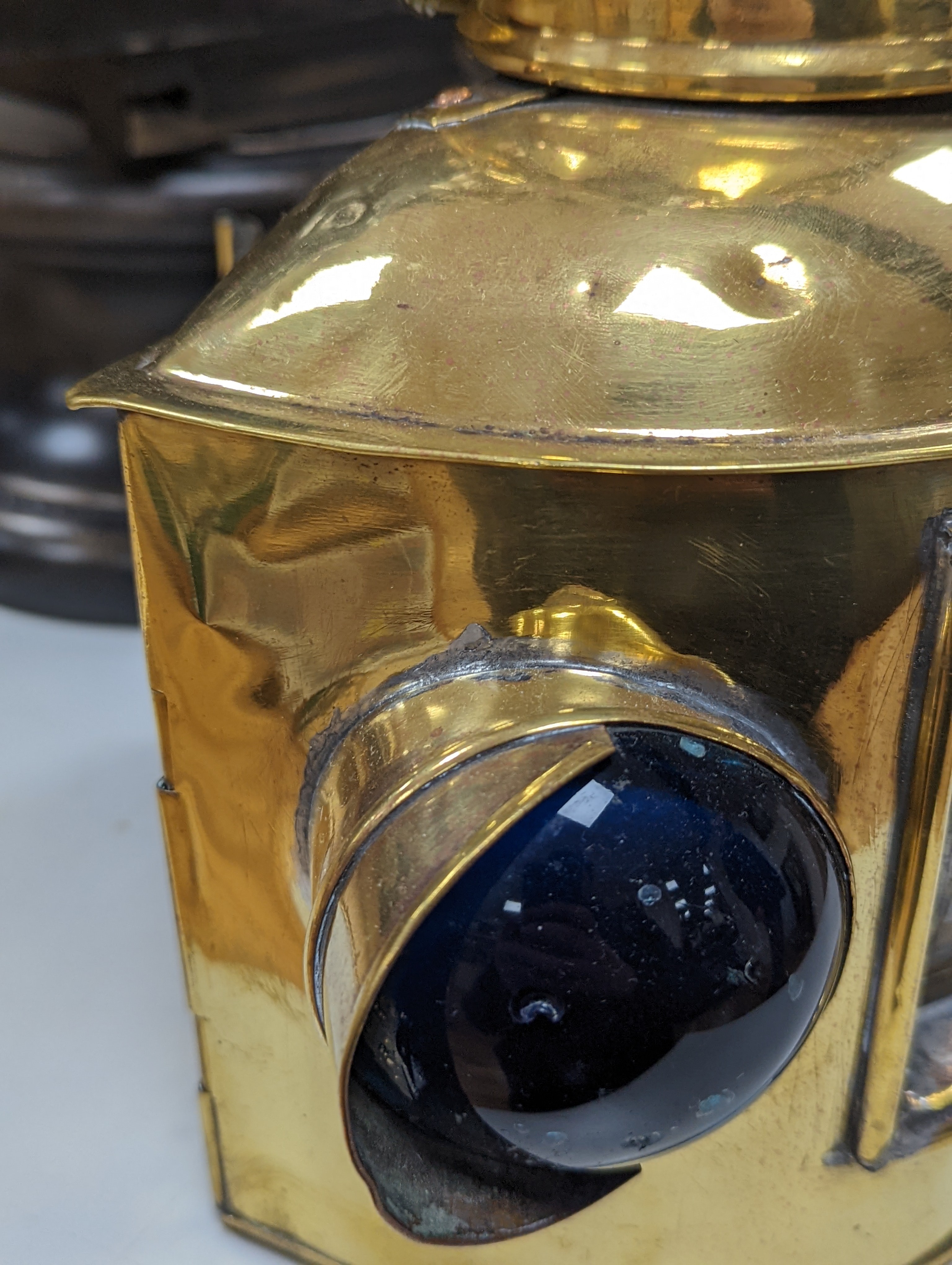 A copper ship's binnacle compass, a brass oil lamp, a brass jug and a copper kettle